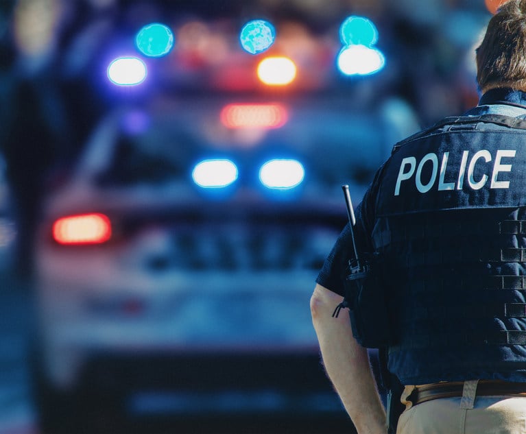 Policeman outside police car