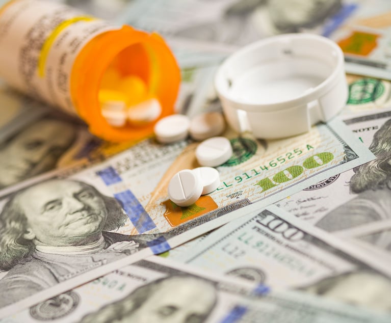 Medicine Pills Scattered on Newly Designed U.S. One Hundred Dollar Bills.