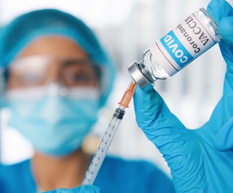 Close up shot of young female healthcare specialist hands holding ampoule with coronavirus vaccine preparing injection for covid vaccination, doctor or nurse in protective uniform work with vaccine