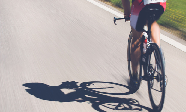Speedy shadow - A cyclist at top speed on the triathlon race.