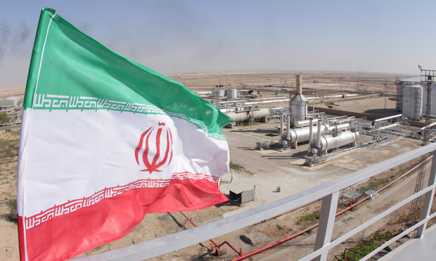 oil and gas refinery in Iran, with Iranian flag