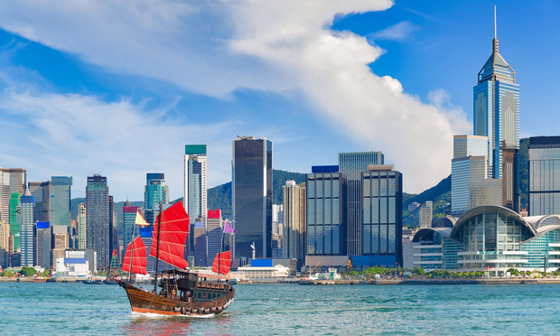 Hong Kong harbor with boats in front of skyline