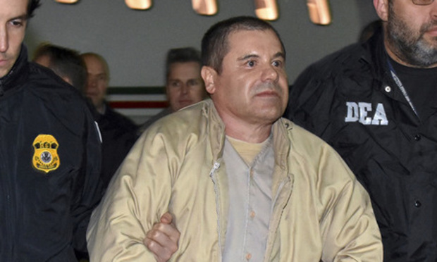 In this Jan. 19, 2017 file photo provided by U.S. law enforcement, authorities escort Joaquin "El Chapo" Guzman from a plane to a waiting caravan of SUVs at Long Island MacArthur Airport, in Ronkonkoma, N.Y.