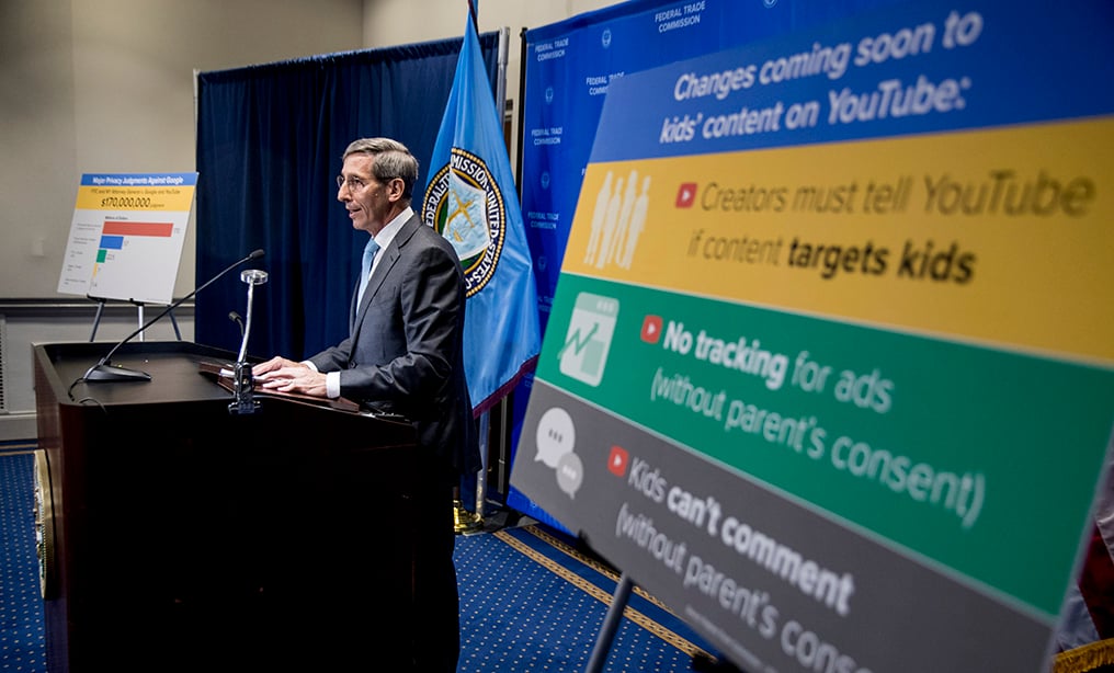 A sign with coming changes to kids' comment on YouTube is displayed as Federal Trade Commission Chairman Joe Simons speaks at a news conference at the Federal Trade Commission in Washington, Wednesday, Sept. 4, 2019, to announce that Google's video site YouTube has been fined $170 million to settle allegations it collected children's personal data without their parents' consent. (AP Photo/Andrew Harnik)