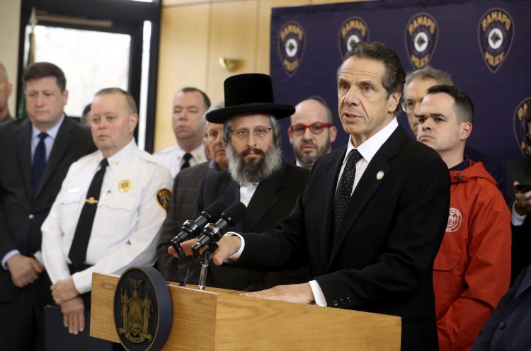 New York Gov. Andrew Cuomo, right, along with police, elected officials and community leaders, speaks Sunday, Dec. 29, 2019, at Ramapo Town Hall in Ramapo, N.Y. about Saturday night's stabbings at a rabbi's home in Monsey. (Seth Harrison/The Journal News via AP)