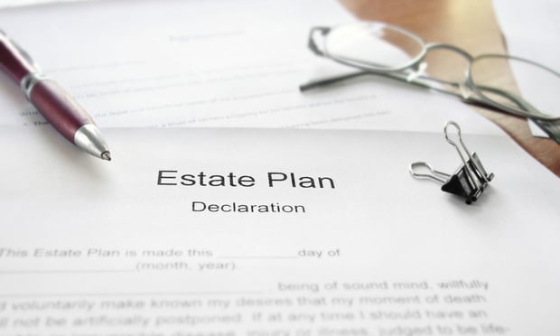 An Estate Plan document on a desk with glasses and pen