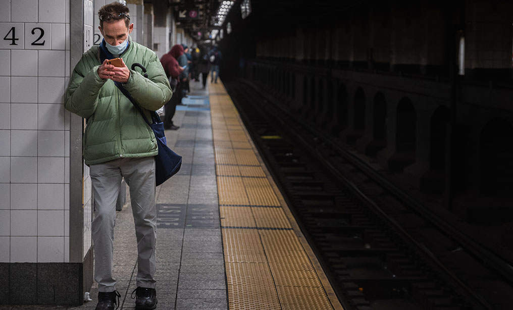 A commuter wears a face mask as he waits on the subway platform during the coronavirus pandemic in New York, Tuesday, March 17, 2020. Photo: Ryland West/ALM