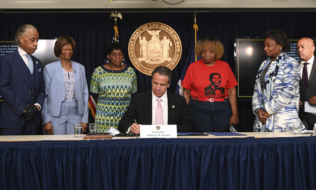 New York Gov. Andrew M. Cuomo signs into law a sweeping package of police accountability measures that received new backing following protests of George Floyd's killing. AP Photo Courtesy of the Office of New York Gov. Andrew M. Cuomo.