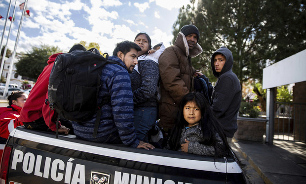 Asylum seekers sit in the back of a Mexican police vehicle after being returned to Nogales, Sonora, Mexico, after making their claims in the United States. Photo: Josh Galemore/AP