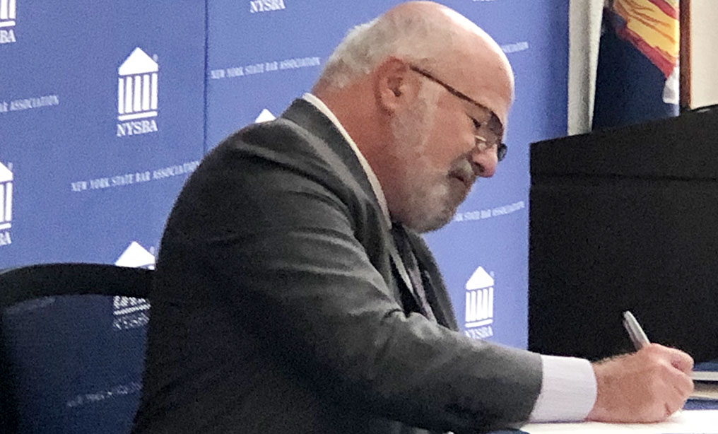 NYSBA President Scott M. Karson signs the MOU with the NBA during a virtual ceremony today with over 500 people in attendance on Thursday, August 13. Photo: Courtesy of the NYSBA