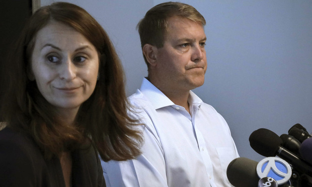 Scott Hapgood, right, a U.S. financial adviser charged with killing a hotel worker while on vacation in Anguilla, and his lawyer Juliya Arbisman, left, hold a press conference in New York in August.