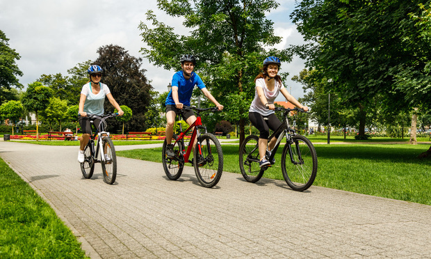 People riding bicycles in a city park