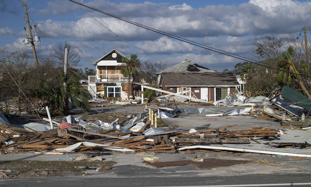 Damaged beach houses stand surrounded by debris after Hurricane Michael hit in Mexico Beach on Oct. 11, 2018. Photographer: Zack Wittman/Bloomberg