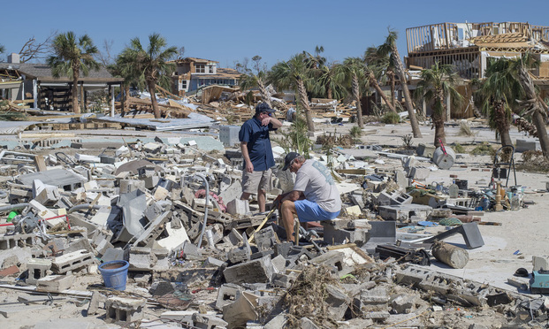 Residents survey debris after Hurricane Michael hit in Mexico Beach, Florida, on Oct. 12. (Photo: Zack Wittman/Bloomberg)