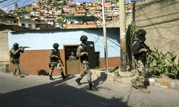 Members the National Police Action Force, an elite commando unit created for anti-gang operations, patrol the Antimano neighborhood of Caracas, Venezuela, Tuesday, Jan. 29, 2019. (AP Photo/Rodrigo Abd)