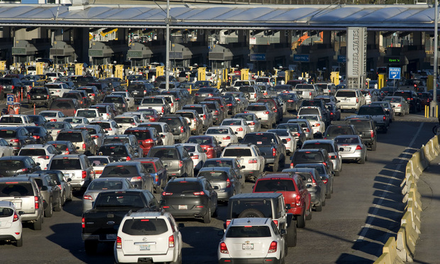 Vehicles stand in morning traffic at the San Ysidro Port of Entry for U.S.-Mexico border crossing in Tijuana, Mexico, on Thursday, Jan. 26, 2017. Photographer David Maung/Bloomberg