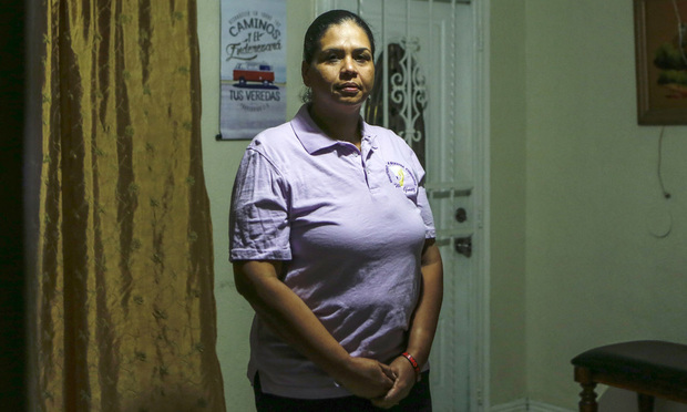 Wanda Gomez, a survivor of domestic violence, poses in her home, in Miami, Fla. (AP Photo/Ellis Rua)