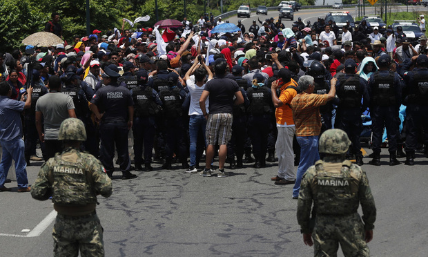 In this June 5, 2019, file photo, Mexican authorities stop a migrant caravan that had earlier crossed the Mexico-Guatemala border, near Metapa, Chiapas state, Mexico. (AP Photo/Marco Ugarte, File)