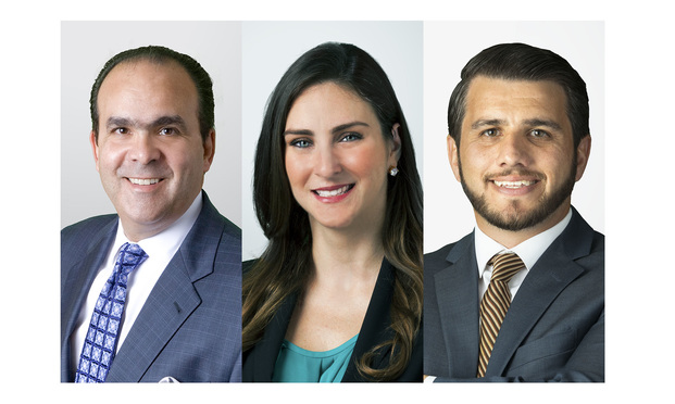 Holland & Knight partners Alberto Hernandez, Elena Otero, and associate Faisal Kraziem in Miami.