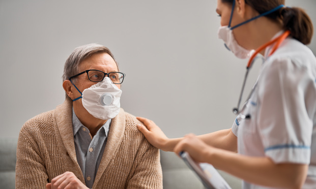 Doctor and man wearing face masks during coronavirus and flu outbreak.