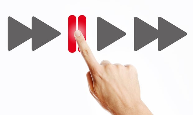 Male hand pressing pause button on the virtual screen.