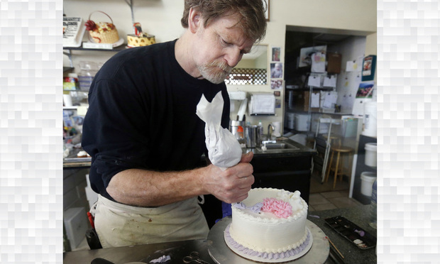  In this March 10, 2014, file photo, Masterpiece Cakeshop owner Jack Phillips decorates a cake inside his store in Lakewood, Colorado.