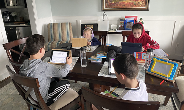 Four of the Merino children engage in online learning. (Courtesy photo)