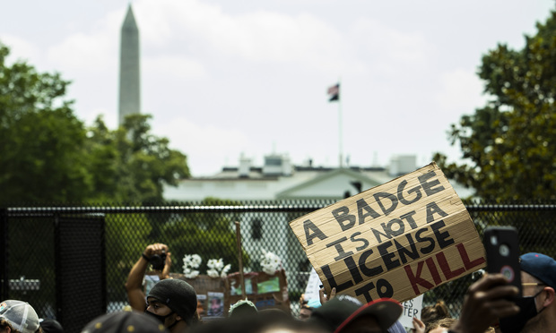 Protesters behind a fence at the White House.