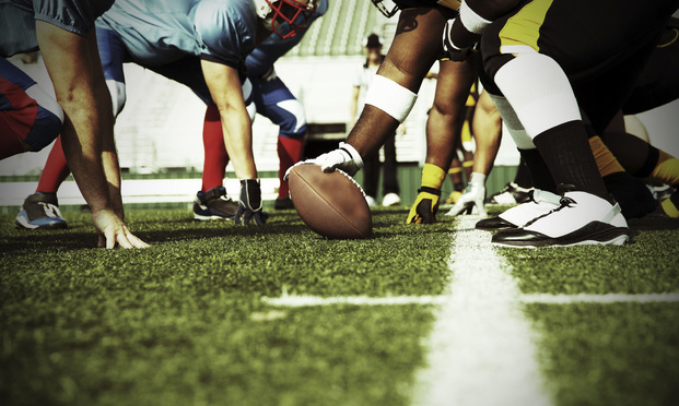 football field with players - Credit: Fotolia