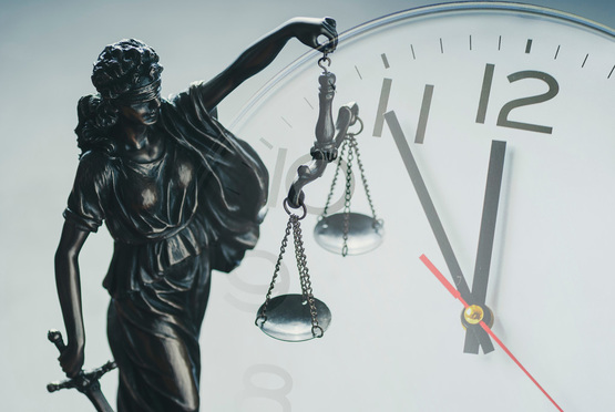 scales of justice with clock