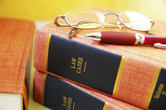 Closeup of law books, glasses and pen