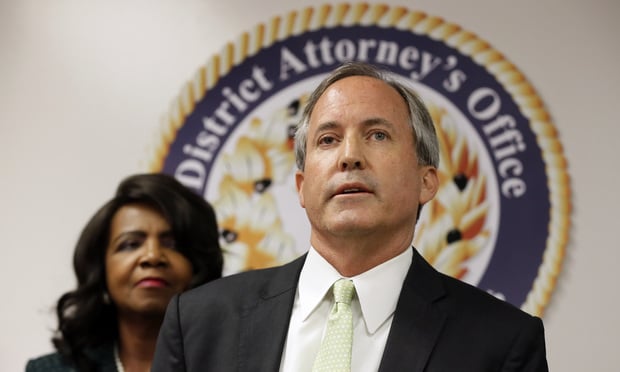 Texas Attorney General Ken Paxton, center, makes comments during a news conference as Dallas County District Attorney Faith Johnson, left, listens, Wednesday, June 22, 2017, in Dallas. (AP Photo/Tony Gutierrez)