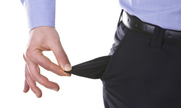 businessman pulling out empty pocket