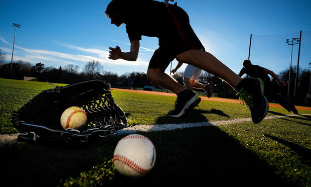 OMAHA. NE - JANUARY 26: A rare winter warm streak brings out baseball players looking to get ready for baseball tryouts January 26, 2015 in Omaha, Neb.  baseball or soft ball, playing, activity, exercise, movement, sunny day, outside, playing, sports, running, stretching
