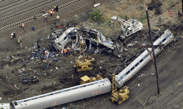 FILE- In this May 13, 2015 file photo, emergency personnel work at the scene of a night derailment in Philadelphia of an Amtrak train headed to New York. Amtrak has started settling lawsuits with victims of last year’s deadly derailment in Philadelphia, and lawyers involved in the process say a strict confidentiality provision prevents them from talking about how they’re doing or how much money they've received. (AP Photo/Patrick Semansky, File)