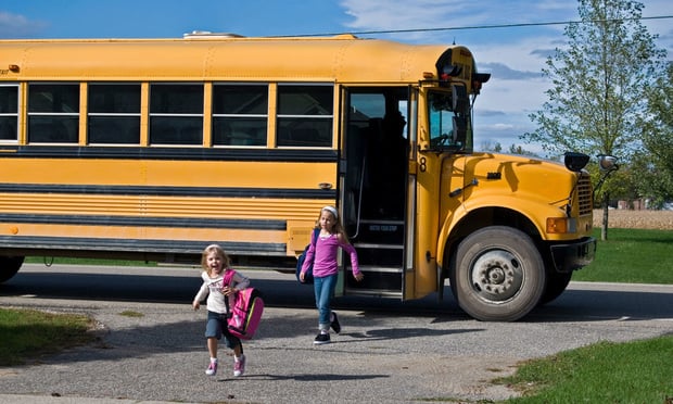 children getting off school bus