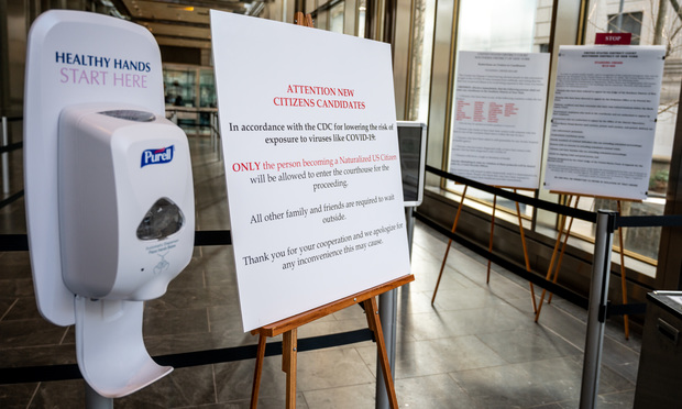 Purell container and sign announcing courts partial closure due to coronavirus
