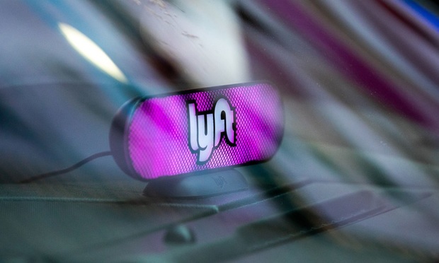 Lyft sign is seen at Time Square in New York, U.S., on Wednesday, May 8, 2019. Simmering tensions between drivers and ride-hailing companies are flaring again, as drivers in major cities across the U.S. and the U.K. went on strike Wednesday over low wages and unstable working conditions. Photographer: Jeenah Moon/Bloomberg