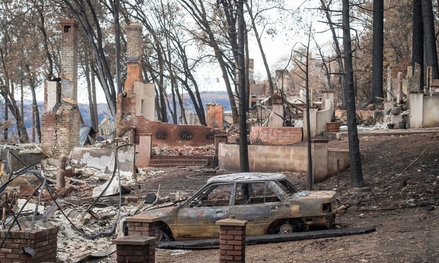 Burned-out homes and vehicles stand in Paradise, California, U.S., on Monday, November 26, 2018. The nation's deadliest wildfire in a century known as the Camp Fire that killed at least 85 people and burned over 14,000 homes has been fully contained after burning for more than two weeks, authorities said Sunday. Photographer: David Paul Morris