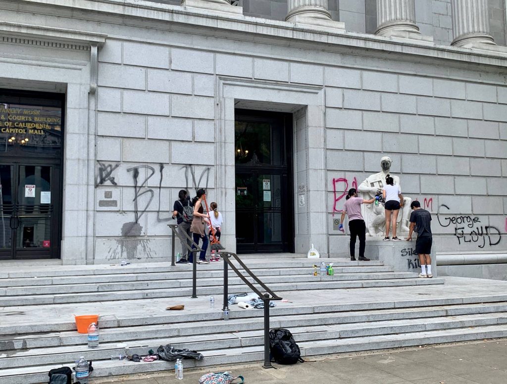 Volunteers clean up graffiti from the Stanley Mosk Library and Courts Building in Sacramento, California, home to the Third District Court of Appeal on May 31, 2020. (Photo courtesy of court officials.)
