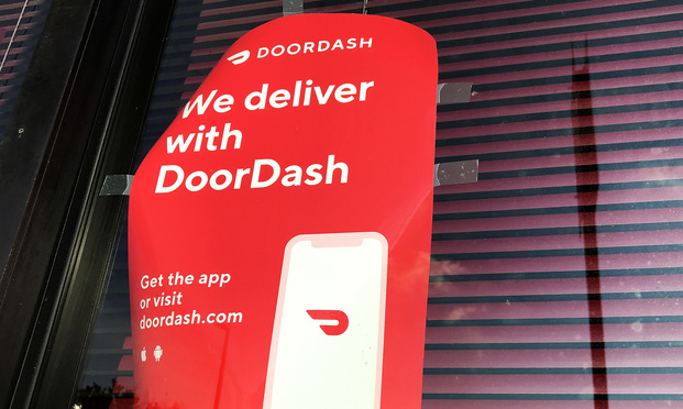 DoorDash sign displayed outside a restaurant in Baltimore, MD.