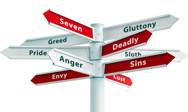 A direction sign listing the seven deadly sins.