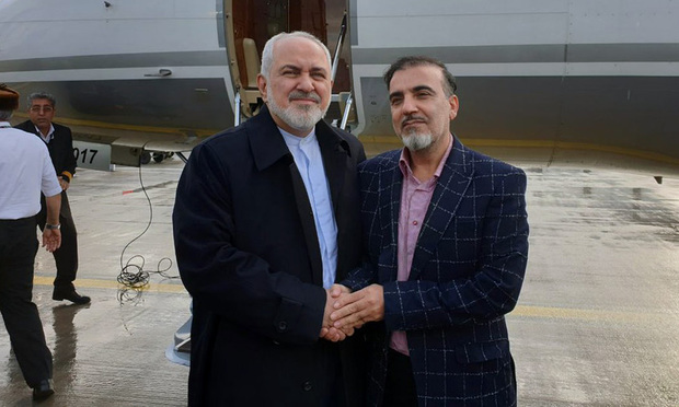 In this photo released on twitter account of Iran's Foreign Minister Mohammad Javad Zarif , Zarif, left, shakes hand with Iranian scientist Massoud Soleimani prior to leaving Zurich, Switzerland for Tehran, Iran, Saturday, Dec. 7, 2019. Iran and the U.S. conducted a prisoner exchange Saturday that saw a detained Princeton scholar released for an Iranian scientist held by America, marking a rare diplomatic breakthrough between Tehran and Washington after months of tensions. (Javad Zarif twitter account via AP)
