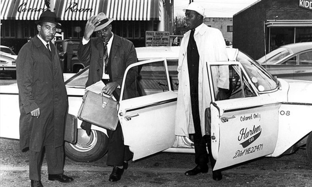 Lawyers C.B. King, Donald Hollowell and Vernon Jordan exit a taxi.