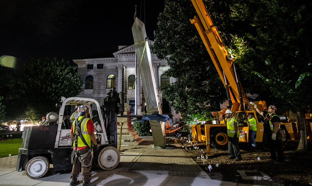Workers remove a Confederate monument with a crane Thursday, June 18, 2020, in Decatur, Ga.