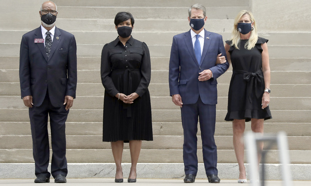 Georgia Gov. Brian Kemp, second from right, his wife Marty Kemp, right, and Atlanta Mayor Keisha Lance Bottoms, second from left, await the casket of Rep. John Lewis at the state capital, Wednesday, July 29, 2020, in Atlanta. Lewis, who carried the struggle against racial discrimination from Southern battlegrounds of the 1960s to the halls of Congress, died Friday, July 17, 2020. (AP Photo/Brynn Anderson)