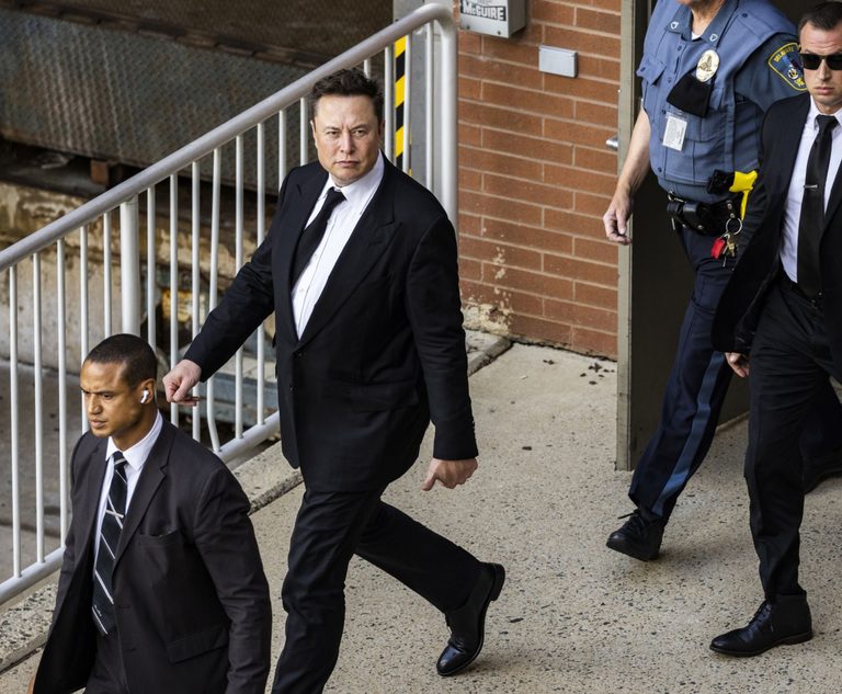 Elon Musk, chief executive officer of Tesla Inc., center, departs from court for the SolarCity trial in Wilmington, Delaware, U.S., on Monday, July 12, 2021. Musk was cool but combative as he testified in a Delaware courtroom that Tesla Inc.'s more than $2 billion acquisition of SolarCity in 2016 wasn't a bailout of the struggling solar provider. Photo: Samuel Corum/Bloomberg