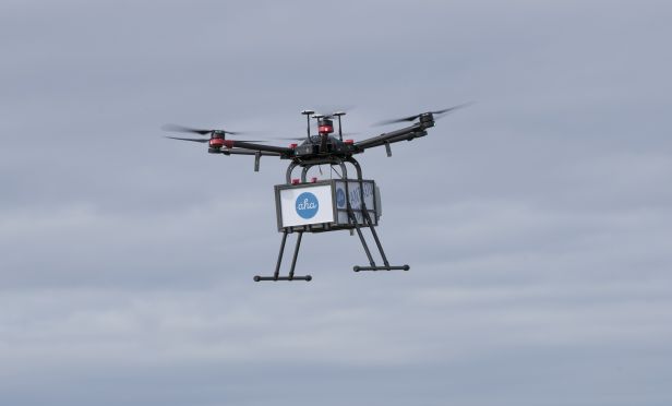 Drone delivering a package.