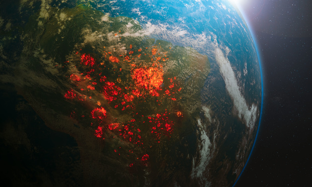 The climate crisis is on track to become the most far-reaching and catastrophic disaster the Earth has ever known. This image is an aerial view from space of the 2020 Brazilian rainforest fires. (Photo: OSORIOartist/Shutterstock)